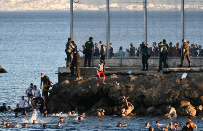 Morocco allows thousands of migrants to swim to the Spanish enclave of Ceuta